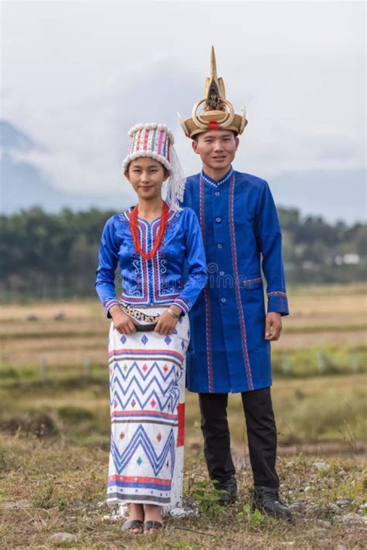 Burma/Myanmar A Kachin couple in ethnic dress. The Shan text