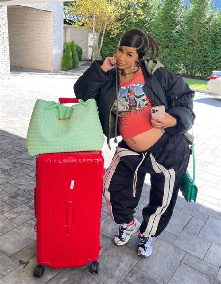 Cardi B shows her growing baby bump in a tee and leggings while out