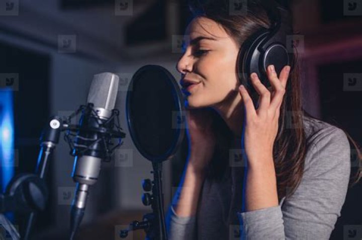 Female vocal artist singing in a recording studio stock photo (132581