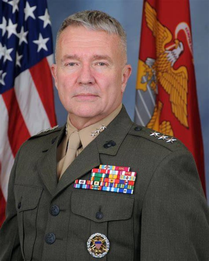 Lt. Gen. McKenzie's wife, Marilyn, and son, pin on his
