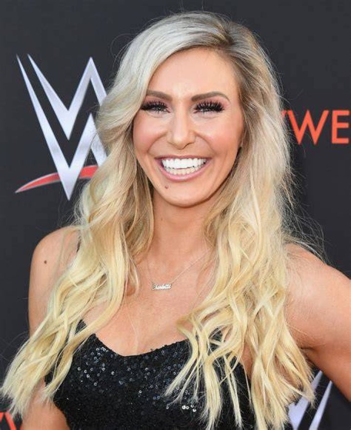 WWE Superstar Charlotte Flair (Ashley Fliehr) holding Monroe Sky